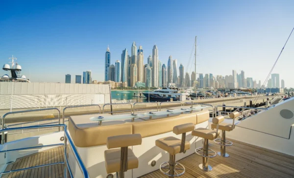 a bar on a boat with a city in the background
